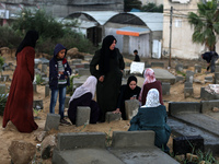 Palestinian women are gathering at a cemetery on the grave of a relative early on the first day of Eid al-Fitr, the Muslim holiday that begi...