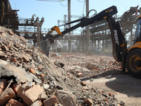 An excavator is removing the rubble at an energy facility that was damaged by Russian shelling and is being repaired in Kharkiv, northeaster...