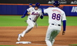 Brett Baty #22 of the New York Mets is rounding third base to score during the fourth inni...