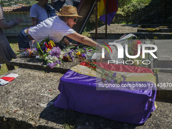 A woman is leaving flowers near the remains of Vicente Martin, a republican who was convicted and executed by the dictatorship during the Sp...