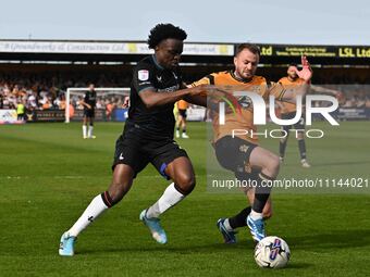 James Gibbons of Cambridge United is being challenged by Tyreece Campbell of Charlton Athletic during the Sky Bet League 1 match at the Cled...