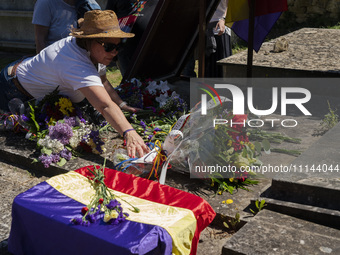 People are placing flowers in the crypt to honor the republican victims who were killed in the Francoist prison of Valdenoceda in Burgos, Sp...