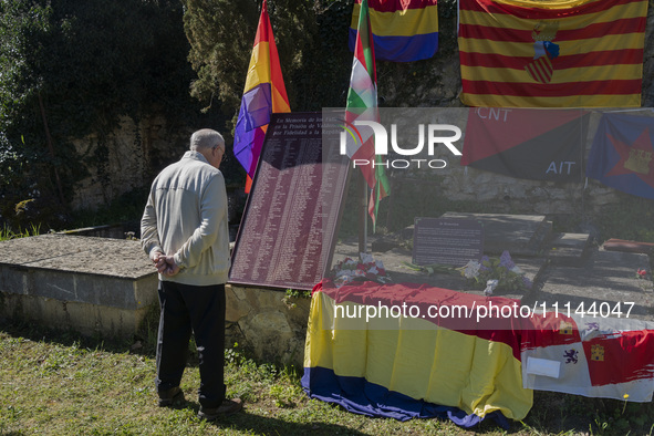 A man is observing the tribute plaque with the names of all those who died in the Valdenoceda prison for their loyalty to the Republic, at t...