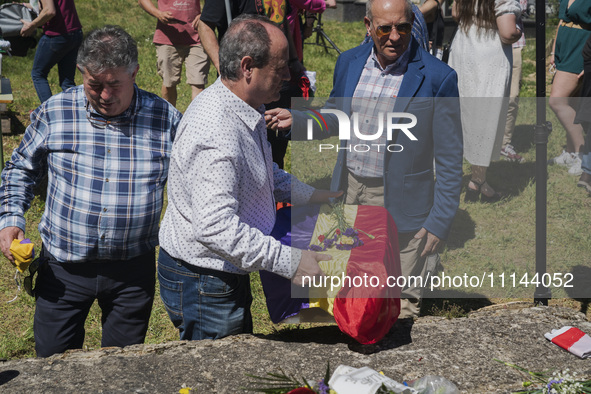 A relative of Vicente Martin Garcia is removing his remains, which have been given to them, at the Valdenoceda cemetery during the annual tr...