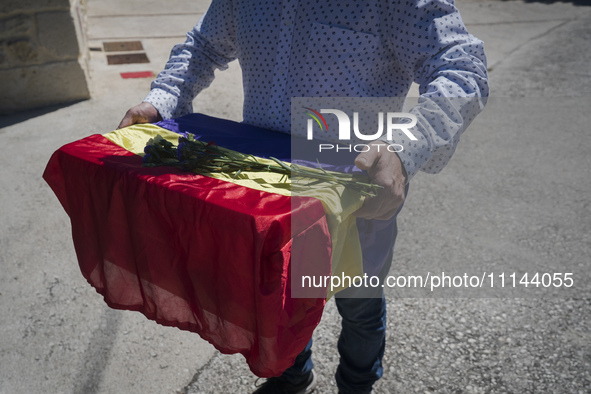 A relative of Vicente Martin Garcia is collecting his remains, which are wrapped in a flag of the republic, at the Valdenoceda cemetery in B...
