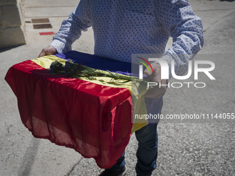 A relative of Vicente Martin Garcia is collecting his remains, which are wrapped in a flag of the republic, at the Valdenoceda cemetery in B...
