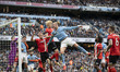 Erling Haaland, wearing the number 9 jersey for Manchester City, is heading the ball durin...