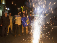 Iranians are celebrating Iran's IRGC UAV and missile attack against Israel, with one person holding a flag of the Islamic Revolutionary Guar...