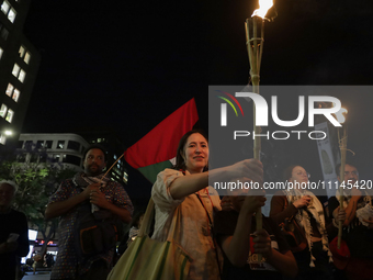 Social organizations are lighting torches while demonstrating outside the Palace of Fine Arts in Mexico City, in solidarity with Palestine a...