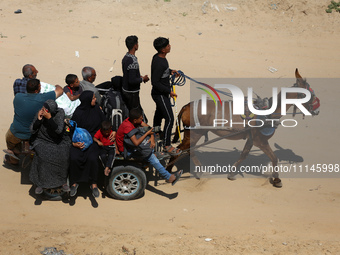 Displaced Palestinians are taking the coastal Rashid road to return to Gaza City as they pass through Nuseirat in the central Gaza Strip ami...
