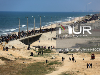 Displaced Palestinians are taking the coastal Rashid road to return to Gaza City as they pass through Nuseirat in the central Gaza Strip on...