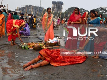 Devotees are performing rituals on the bank of the River Brahmaputra on the occasion of the Chaiti Chhath festival in Guwahati, India, on Ap...