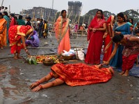 Devotees are performing rituals on the bank of the River Brahmaputra on the occasion of the Chaiti Chhath festival in Guwahati, India, on Ap...