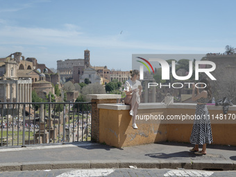 A tourist is taking a photo with the ruins of ancient Rome in the background in Rome, Italy, on April 8, 2024. Featuring 25,000 archaeologic...