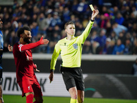 Referee Francois Letexier is showing a yellow card during the UEFA Europa League quarter-finals second leg football match between Atalanta B...