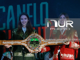 Hostesses are showing the commemorative boxing belt during a press conference for the fight between Saul ''Canelo'' Alvarez and Jaime Mungui...