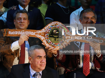 President of the World Boxing Council (WBC), Mauricio Sulaiman (L), accompanied by the Governor of Tamaulipas, Americo Villareal, is showing...