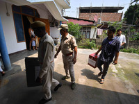 Polling officials are arriving at a home in Nagaon district, Assam, India, on April 21, 2024, to collect postal ballots cast by senior citiz...