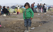  A migrant child stands at a makeshift camp at the Greek-Macedonian border, near the Greek...