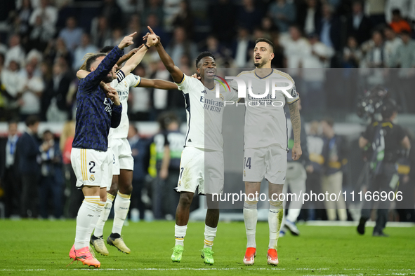 Vinicius Junior left winger of Real Madrid and Brazil and Joselu centre-forward of Real Madrid and Spain celebrate victory after the UEFA Wo...