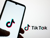The TikTok logo is being displayed on a smartphone screen and on a computer screen in Athens, Greece, on April 22, 2024. (
