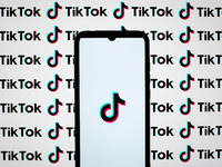 The TikTok logos are being displayed on a smartphone screen and on a computer screen in Athens, Greece, on April 22, 2024. (
