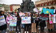 Members of Kazakhstan diaspora and supporters hold banners while attending 'Justice for Sa...