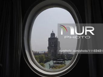 A view of the Metropolitan Cathedral is being seen through a hotel window in the Zocalo of Mexico City. (