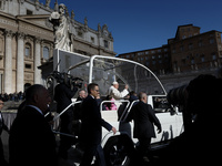 Pope Francis is waving to the faithful from his popemobile at the end of a weekly general audience in St. Peter's Square, at the Vatican, on...