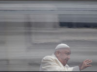 Pope Francis is waving to the faithful from his popemobile at the end of a weekly general audience in St. Peter's Square, at the Vatican, on...
