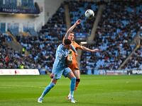 Bobby Thomas of Coventry City is being challenged by Liam Delap of Hull City during the Sky Bet Championship match at the Coventry Building...