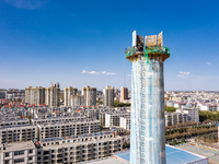 An aerial photo is showing the demolition of a chimney at the Thermal Company in Jiuquan, Gansu Province, China, on April 20, 2024. (