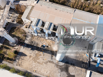 An aerial photo is showing the demolition of a chimney at the Thermal Company in Jiuquan, Gansu Province, China, on April 20, 2024. (