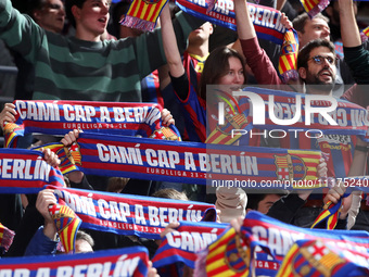 FC Barcelona supporters are cheering during the match between FC Barcelona and Olympiacos Piraeus for the first game of the Play-off of the...