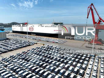 Roll-on wheels are loading new energy vehicles for export at the terminal of Orient Port Branch in Lianyungang Port, Jiangsu Province, China...