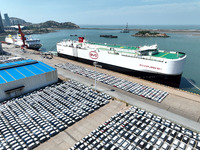Roll-on wheels are loading new energy vehicles for export at the terminal of Orient Port Branch in Lianyungang Port, Jiangsu Province, China...