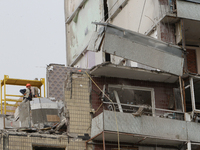 A worker is dismantling a section of the apartment building at 118 Naberezhna Peremohy Street in Dnipro, Central Ukraine, on April 25, 2024,...