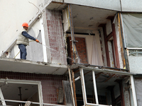 A worker is dismantling a section of the apartment building at 118 Naberezhna Peremohy Street in Dnipro, Ukraine, on April 25, 2024, that wa...