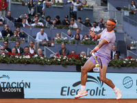 Rafael Nadal is returning a shot against Darwin Blanch during their match on Day 4 of the Mutua Madrid Open at Caja Magica Stadium in Madrid...