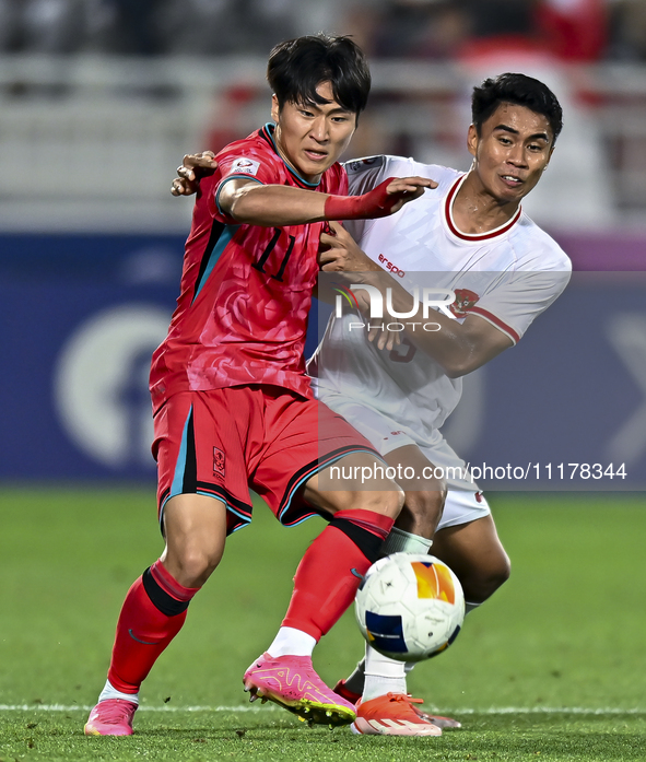 Muhammad Ferrari (R) of Indonesia is battling for the ball with Jeong Sangbin of South Korea during the AFC U23 Asian Cup Qatar 2024 quarter... by Noushad Thekkayil/NurPhoto