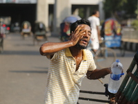 A rickshaw puller is splashing water on his face to find relief from a heatwave in Dhaka, Bangladesh, on April 26, 2024. (