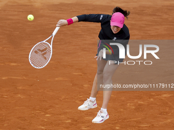 Iga Swiatek of Poland is in action against Xiyu Wang of China in their Women's Singles second round match on Day Three of the Mutua Madrid O...