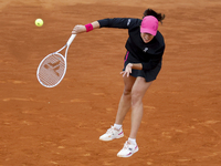 Iga Swiatek of Poland is in action against Xiyu Wang of China in their Women's Singles second round match on Day Three of the Mutua Madrid O...