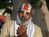 A Hindu holy man is showing his inked finger after casting his vote at a polling station during the second phase of the Indian General Elect...