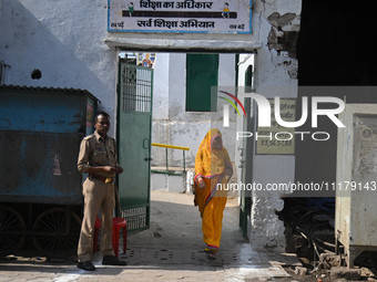A woman is walking out after casting her vote at a polling station during the second phase of the Indian General Elections in Vrindavan dist...