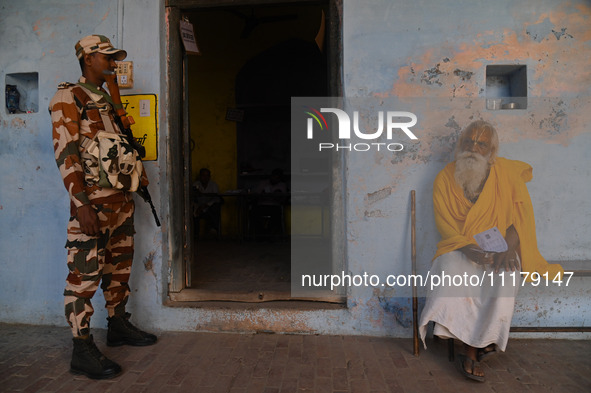 A Hindu holy man is sitting outside a polling station during the second phase of the Indian General Elections in Vrindavan district, Uttar P...