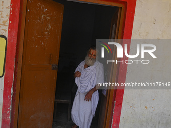 A Hindu holy man is walking out after casting his vote at a polling station during the second phase of the Indian General Elections in Vrind...
