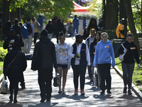 People are walking on campus while protesters are setting up camp to protest the Gaza conflict at the University of Pennsylvania in Philadel...