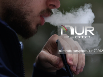A person smokes an electronic cigarette in Krakow, Poland on April 9, 2022. (