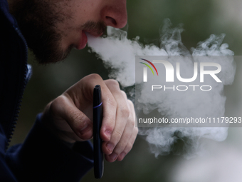 A person smokes an electronic cigarette in Krakow, Poland on April 9, 2022. (